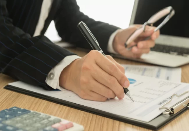 A person writing on a piece of paper