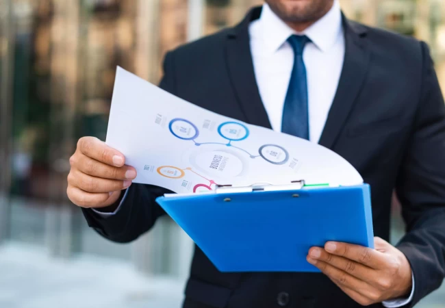 a man holding a clipboard and Documents Required for a DMCC Audit