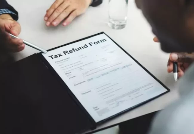 A man looking at a tax refund form